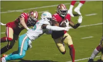  ?? TONY AVELAR — THE ASSOCIATED PRESS, FILE ?? San Francisco 49ers running back Raheem Mostert (31) runs against Dolphins outside linebacker Jerome Baker (55) during the first half on Oct. 11 in Santa Clara.