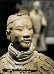  ?? STEVE HELBER — THE ASSOCIATED PRESS ?? In a Tuesday photo, Terracotta Army soldiers are on exhibit at the Virginia Museum of Fine Arts in Richmond, Va. The Museum has 10 of the majestic terracotta figures on display as part of an exhibit that tells the story of the first emperor of China...