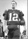  ?? AP/CHARLES KRUPA ?? New England Patriots quarterbac­k Tom Brady leaves a foggy field at Gillette Stadium after a 23-7 victory over the Atlanta Falcons on Sunday night.