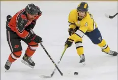  ?? Matt Freed/Post-Gazette ?? Bethel Park's Nick Massari, left, battles Mt. Lebanon's Jackson Klasnick for the puck in a game in January. Bethel Park has gotten plenty of ice time this season, having played 18 of its 20 regular-season games.