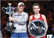  ?? - Reuters – Reuters ?? THRILLER: Denmark’s Caroline Wozniacki, left, and Romania’s Simona Halep pose with their trophies after the women’s singles final of the Australian Open in Melbourne on Saturday.