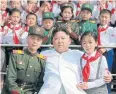  ??  ?? SO MANY OBSTACLES: School children stand beside North Korean leader Kim Jong-un in Pyongyang. A dictionary may be needed as part of unity efforts.