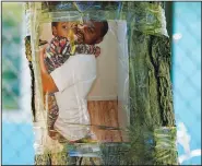  ?? ?? A photo of Roberts is seen taped to a tree July 12 near where the shooting took place.