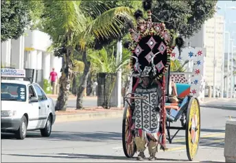  ?? PHOTO: BAFANA
MAHLANGU ?? MUSCLE POWER: John Ndwandwe makes his living from operating a rickshaw along Durban’s beach front. He has taught his son the same trade, but the family could soon be out of business