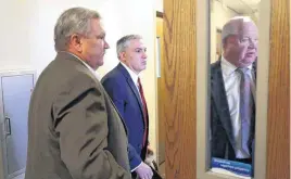  ??  ?? Wagoner County Sheriff Bob Colbert, left, walks into the Wagoner County courtroom of Judge Darrell Shepherd on Wednesday. He agreed to a voluntary suspension of his position.