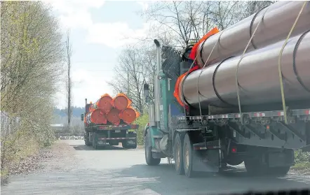  ?? — WILDERNESS COMMITTEE ?? Last Thursday, pipe was delivered to a staging area in New Westminste­r for Kinder Morgan’s $7.4-billion Trans Mountain oil pipeline expansion. The delivery happened four days after the company said it was suspending all non-essential spending unless...