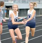  ?? ?? Keeley Carpenter hands the baton off to Ellen Scott Tuesday.