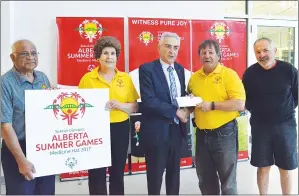  ?? NEWS PHOTO TIM KALINOWSKI ?? Alberta Special Olympic Summer Games committee chair Brian Varga accepts a grant of more than $75,000 from MLA Bob Wanner on behalf of the province. Also pictured, local Summer Games organizers John John, Val Miller and Mike Borden.