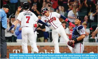  ?? AFP ?? ATLANTA: Dansby Swanson #7 of the Atlanta Braves celebrates with Johan Camargo #17 after hitting a three run home run during the seventh inning against the Washington Nationals at SunTrust Park on Friday in Atlanta, Georgia. —