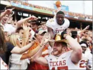  ?? COOPER NEILL — THE ASSOCIATED PRESS FILE ?? Texas tight end Andrew Beck (47) wears the Golden Hat and celebrates with fans after defeating Oklahoma 48-45 at the Cotton Bowl in Dallas.