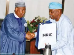  ??  ?? From left: Nigeria Deposit Insurance Corporatio­n (NDIC) MD/CEO, Umaru Ibrahim, presenting NDIC Souvenir to the Chairman, Alumni Associatio­n of the National Institute for Policy and Strategic Studies Abuja Chapter, Arc. Bola A. Balogun, during a...