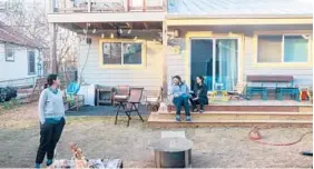  ?? ILANA PANICH-LINSMAN/THE NEW YORK TIMES ?? Marla Torrado and Adam Keeling sit on the porch of the accessory dwelling unit behind their home Jan. 16 in Austin, Texas. Torrado’s sister, Lorna, left, is living there until their parents move in.