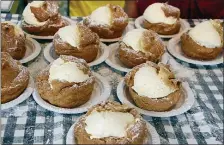  ??  ?? Calories? Cleveland Oktoberfes­t has a few, with treats such as these giant cream puffs.