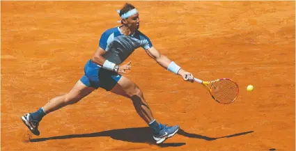  ?? — GETTY IMAGES ?? Rafael Nadal of Spain plays a running forehand to American John Isner in their second-round singles match at the Internazio­nali BNL D'Italia at Foro Italico on Wednesday in Rome, Italy.