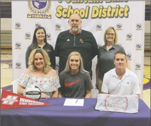  ?? The Sentinel-Record/Richard Rasmussen ?? REDDIE TO PLAY: Fountain Lake outside hitter Olivia Cox, front center, signed a national letter of intent Tuesday at Irvin J. Bass Gymnasium to play college volleyball for Henderson State University. With Cox, in front, from left are her mother Julie...