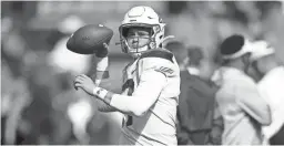  ??  ?? Arizona quarterbac­k Grant Gunnell warms up before a game against Colorado on Oct. 5 in Boulder, Colo.