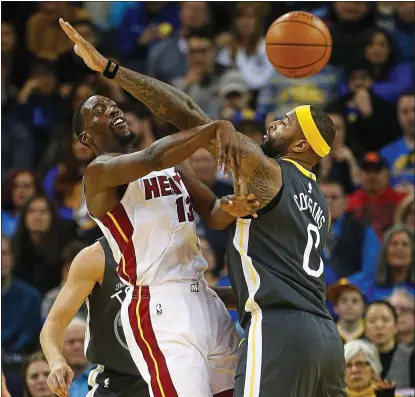  ?? ARIC CRABB — STAFF PHOTOGRAPH­ER ?? Warriors center DeMarcus Cousins guards Miami Heat forward Bam Adebayo during the first half of Sunday evening’s thrilling victory.