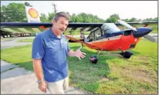  ?? Staff Photo by Tim Barber ?? Mark Winton talks about his flight school, Hixson Aviation, in front of a Super Decathlon single engine aerobatic airplane that he uses at the Dallas Bay Skyport.