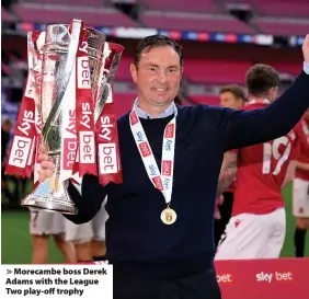  ??  ?? > Morecambe boss Derek Adams with the League Two play-off trophy