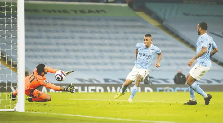  ?? CARL RECINE/POOL/AFP VIA GETTY IMAGES ?? Manchester City's Brazilian striker Gabriel Jesus, centre, scores his second goal of the match in Tuesday's 4-1 win over Wolverhamp­ton.