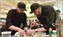  ??  ?? Carmen’s Group executive chef Kyle Dren, left, and John Risidore prepare arepas with a coffee poached egg and coffee demi-glace.