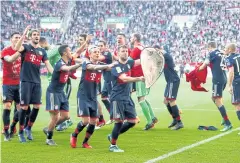  ?? REUTERS ?? Bayern Munich players celebrate winning the league with a replica trophy.