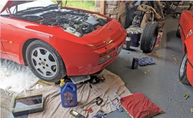  ??  ?? ABOVE and RIGHT: Although the 944 Turbo hasn’t done a huge mileage since the last oil change, Martyn still thought that it would be a good idea to do a fluid and filter change. The dyno tape on the filter records the mileage and date when this work was carried out. The cushion in the photograph, upon which Martyn rests his head when working beneath the car(s), has become a workshop essential!