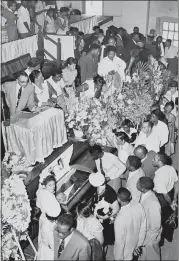  ?? THE ASSOCIATED PRESS ?? Mourners pass Emmett Till’s casket in Chicago in September 1955. Till, 14, was an African American boy who was kidnapped, tortured and lynched by a white mob for allegedly whistling at a white woman in Mississipp­i.