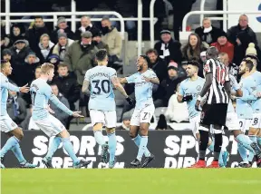  ?? AP ?? Manchester City’s Jamaica-born Raheem Sterling (centre) celebrates with teammates after scoring his side’s only goal during their English Premier League match against Newcastle United at St James’ Park yesterday.