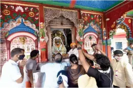  ?? — PTI ?? Devotees visit Hanuman Garhi temple, a day after PM Modi laid foundation for the constructi­on of Ram temple, in Ayodhya, on Thursday.