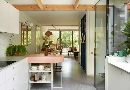  ??  ?? ABOVE The kitchen combines Ikea cabinets with custom fronts by Reform and a marble splashback and worktop from Alpha Marble & Granite. The set of green 1950s Branksome China jugs belonged to Harriet’s greataunt. LEFT Vintage Polish posters by Andrzej Krajewski from Projekt 26.