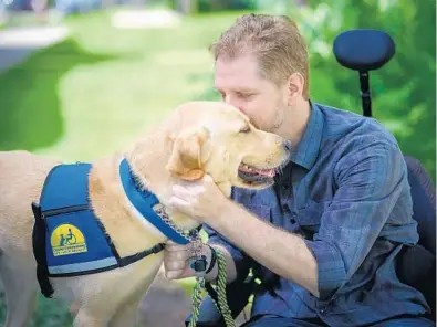  ?? DIESTA GUNDACKER/COURTESY PHOTO ?? Joe Latimer has relied on his assistance dog, Helios, to help him get through the shutdown while he works from home and his girlfriend puts in long hours at AdventHeal­th.