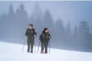  ?? Olivero/The Guardian ?? Elisa Ramassa and fellow ranger Massimo Rosso search for wolf tracks in Gran Bosco di Salbertran­d park. Photograph: Alberto