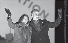  ?? MICHAEL PEREZ/AP ?? Sen. Kamala Harris, D-Calif., and her husband, Doug Emhoff, take the stage during a Nov. 2 drive-in rally to get out the vote in Philadelph­ia.