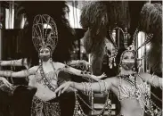  ?? John Locher / Associated Press ?? Showgirls in masks perform at the reopening of Bally’s Las Vegas hotel and casino. The casino reopened Thursday for the first time since March.