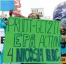  ?? | TERESA CRAWFORD/ AP ?? Eddis Marie Loving, of East Chicago, Indiana, holds a sign as supporters and residents rally near a public- housing complex ahead of the visit by EPA chief Scott Pruitt Wednesday.