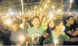  ?? AP ?? Soccer fans chant slogans during a candleligh­t vigil for supporters of Arema FC who died in Saturday’s stampede in Medan, North Sumatra, Indonesia, on Monday, October 3.