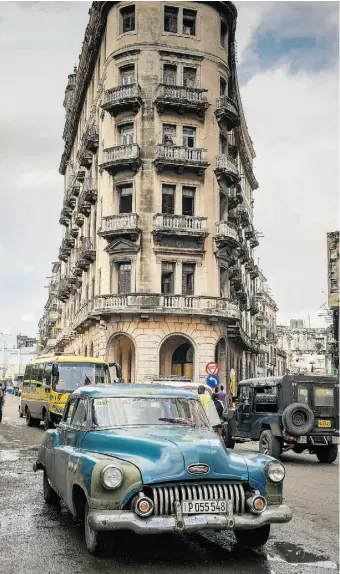  ?? ADALBERTO ROQUE / AFP / Gett
y Imag
es ?? Vintage American cars are ubiquitous in Havana. Cubans are apprehensi­ve about the normalizat­ion of relations with the United States, John Moore writes.