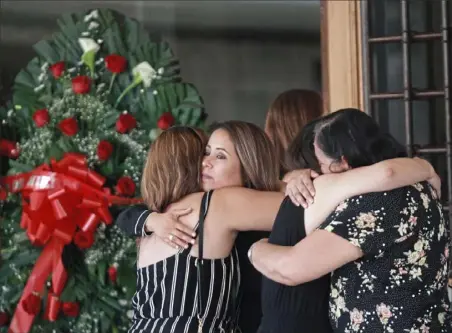  ?? Christian Chavez/ Associated Press ?? Tearful mourners hug outside a funeral home as they arrive to attend a wake for Elsa Mendozaon Wednesday in Juarez, Mexico. Ms. Mendoza, an elementary school teacher in Juarez, was killed in the El Paso mass shooting.