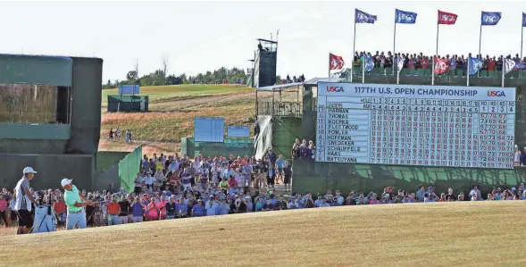  ?? RICK WOOD / MILWAUKEE JOURNAL SENTINEL ?? Brooks Koepka watches his approach shot to the green at the 18th hole. Koepka birdied three consecutiv­e holes on the back nine to pull away from the field. He finished with a 67 on Sunday.