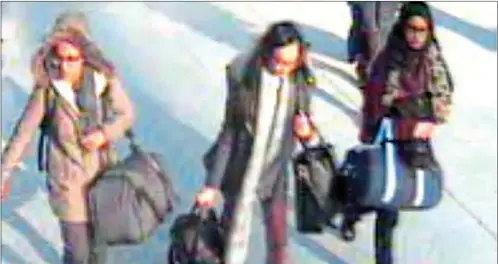  ??  ?? On their way: Bethnal Green schoolgirl­s Amira Abase, left, Khadiza Sultana, centre, and Shamima Begum were caught on CCTV as they walked through Gatwick Airport on their way in 2015 to catch a flight to Turkey. They then crossed the border with Syria...