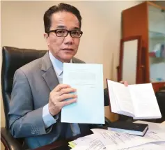  ??  ?? Liew shows a copy of the amendment Bill (left) and the present Federal Constituti­on during the interview.