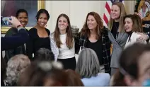  ?? PATRICK SEMANSKY — THE ASSOCIATED PRESS ?? Current and former members of the U.S. Women's national soccer team pose for a photo with House Speaker Nancy Pelosi in March.