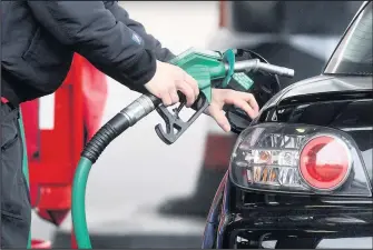  ??  ?? ■
A person using a petrol pump. (Lewis Whyld/PA Wire)