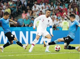  ?? FRANCISCO SECO/THE ASSOCIATED PRESS ?? Portugal’s Cristiano Ronaldo, centre, has long been regarded as one of the sport’s greatest talents, and now rising French superstar Kylian Mbappe is drawing comparison­s to him.