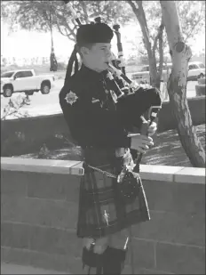  ?? PHOTO BY JAMES GILBERT/YUMA SUN ?? A FIREFIGHTE­R FROM THE YUMA Fire Department’s Pipes and Drums detail playing the bagpipes.