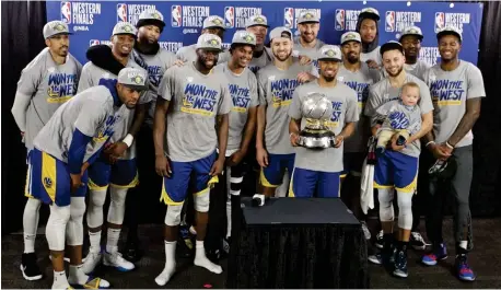  ??  ?? THE Golden State Warriors players pose with the Western Conference Championsh­ip trophy after Game 4 of the NBA basketball playoffs Western Conference finals against the Portland Trail Blazers Monday, May 20, 2019, in Portland, Ore. The Warriors won 119-117 in overtime. (AP)