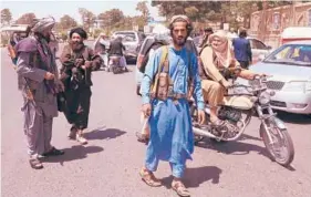 ?? GETTY-AFP ?? Taliban fighters fan out Saturday and patrol Herat, Afghanista­n’s third largest city, which they seized in recent days.