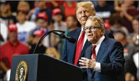  ?? CAROLYN KASTER / ASSOCIATED PRESS ?? President Donald Trump stands with then gubernator­ial candidate Mike DeWine at a rally in Cleveland the day before the midterm election.