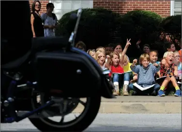  ?? NWA Democrat-Gazette/ANDY SHUPE ?? Ella Lausin, 9 (from left); Makenzie Warren, 10; Owen Chandler, 9; and Jacob Nordin, 9; all fourth-graders at Washington Elementary School, cheer Thursday while counting motorcycle­s as they pass by on Dickson Street in Fayettevil­le. The students were...